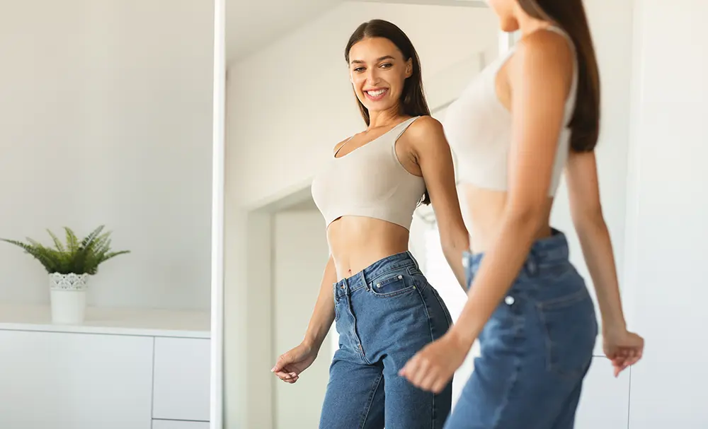 Woman smiling with her reflection in the mirror