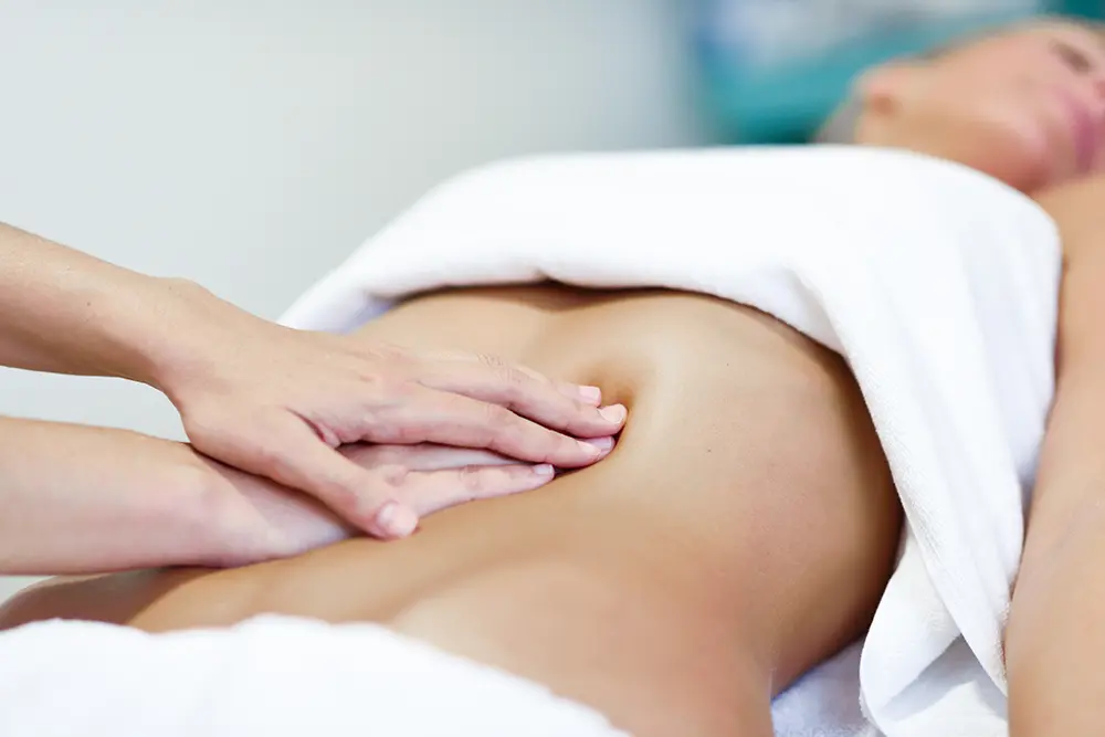Massaging a woman's abdomen