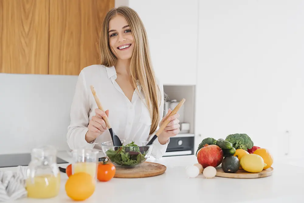 Smiling woman preparing a salad