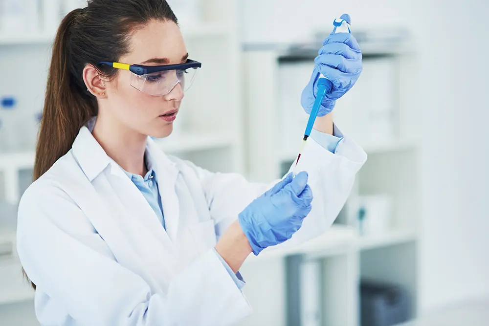 Woman in a lab testing chemicals