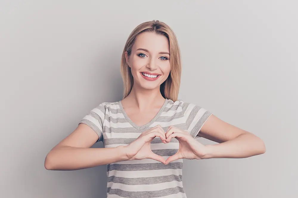 Woman with heart shape hands