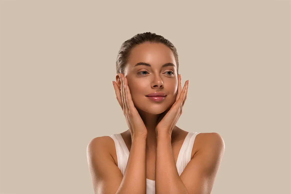 Beauty woman with hands healthy natural make up clean fresh skin concept color background brown